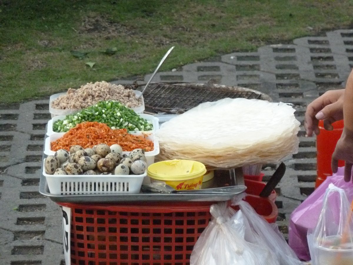 Banh trang nuong cooked at a street stall in Ho Chi Minh City — representative of the cuisine, not a photo of any restaurant on this list
